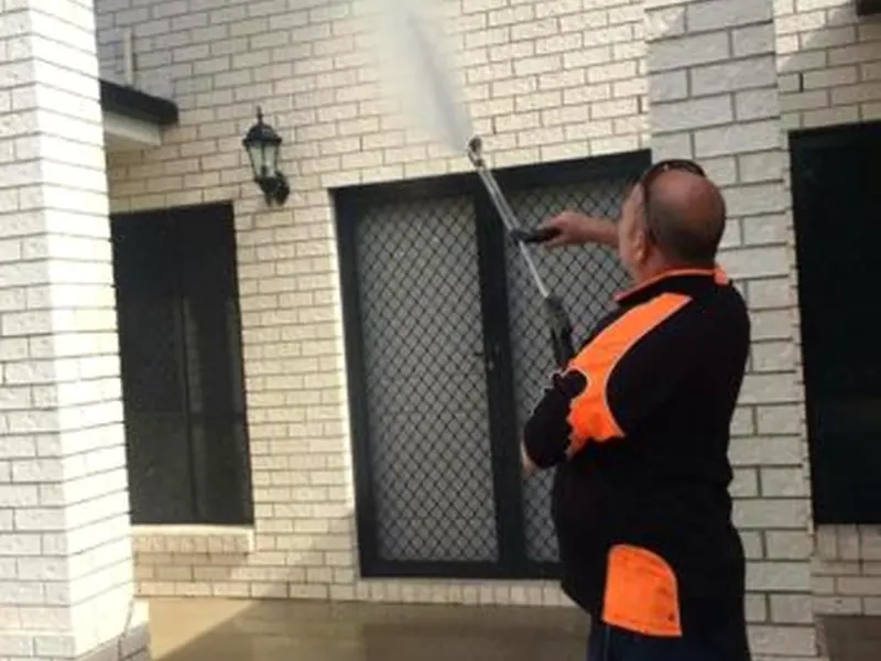 Brick house exterior being soft washed