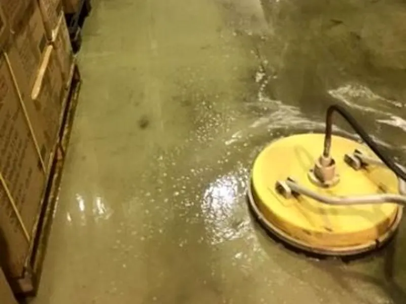 Professional rotary surface cleaning equipment washing a commercial floor