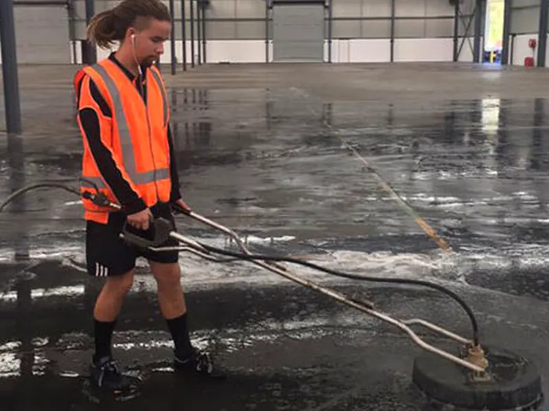 Rotary surface cleaner washing a large commercial hardstand