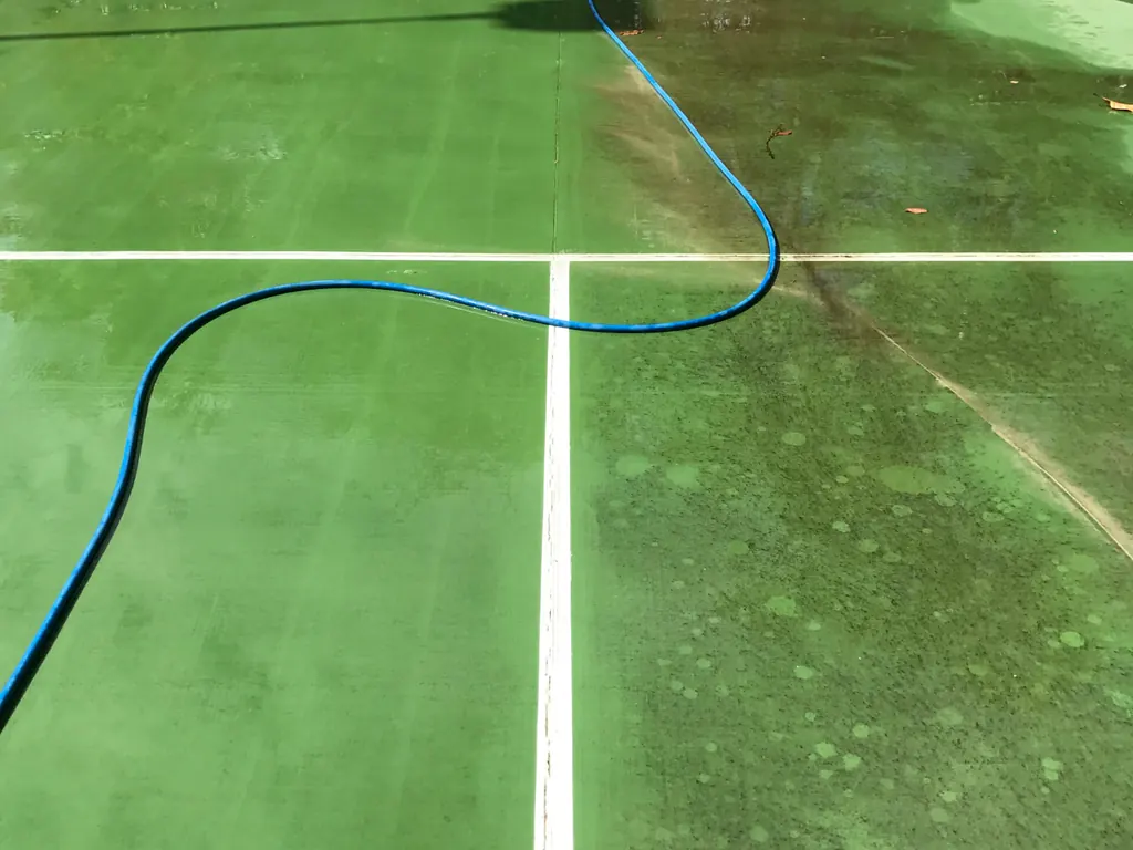 Tennis court showing a clear difference during pressure cleaning